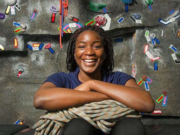 Esther Ebuehi poses for a photo at the rock wall inside of the Activities and Recreation Center on the UC Davis campus.